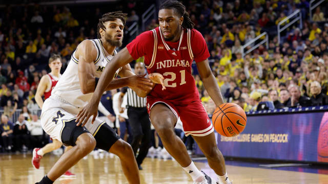 Dec 5, 2023; Ann Arbor, Michigan, USA; Indiana Hoosiers forward Mackenzie Mgbako (21) dribbles against Michigan Wolverines forward Tray Jackson (2) in the second half at Crisler Center.